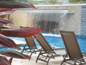 a group of chairs sitting in front of a waterfall at Puerta diamante acapulco in Acapulco