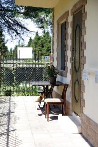 a patio with a table and chairs next to a building at Emili in Pizunda