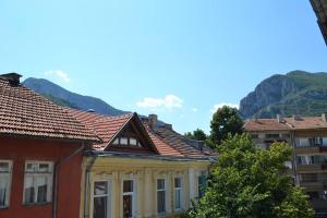 a group of buildings with mountains in the background at Hotel Rade 1 in Vratsa