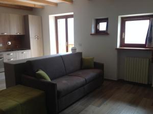 a living room with a couch and some windows at Cianfuran 2 in Bardonecchia