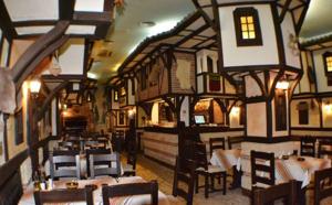 a restaurant with tables and chairs in a building at Perla Dorobanti Apartment in Bucharest