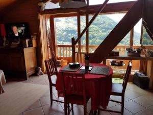 a table and chairs in a room with a large window at Arpege Des Neiges in Sainte-Foy-Tarentaise