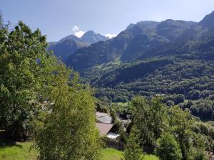 a view of a valley with trees and mountains at Arpege Des Neiges in Sainte-Foy-Tarentaise