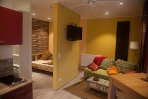 a living room with a couch and a bed at ApartmentHotel Vollumen in Redwitz an der Rodach