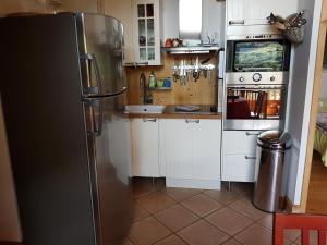 a kitchen with a stainless steel refrigerator at Arpege Des Neiges in Sainte-Foy-Tarentaise