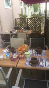a picnic table with bread and other food on it at Hotel des Remparts in Villeneuve-sur-Lot