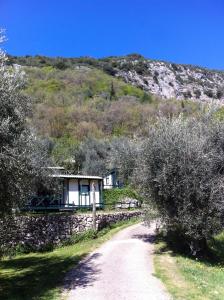 a house on a hill with a dirt road at Camping Domaine Sainte Madeleine in Sospel