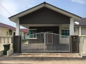 a house with a gate in front of it at Ceri Merah Homestay in Kuantan