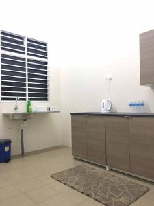 a kitchen with a sink and a counter top at Ceri Merah Homestay in Kuantan