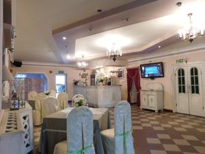 a banquet room with tables and chairs and a tv at Zajazd Fakir in Tapkowice