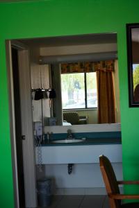 a bathroom with a sink and a mirror at Retro Inn at Mesa Verde in Cortez