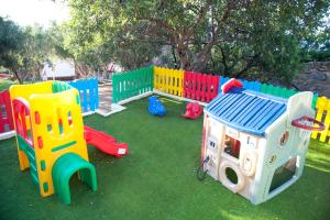 a playground with colorful play equipment on the grass at Elpida Village in Istro