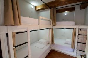 a room with a bed, a toilet and a window at Life is Good Cartagena Hostel in Cartagena de Indias