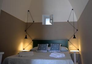 a bedroom with a bed with two pillows on it at Dammuso SOLMAR in Pantelleria