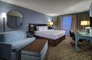 a hotel room with a bed and a desk at Crowne Plaza Chicago O'Hare Hotel & Conference Center, an IHG Hotel in Rosemont