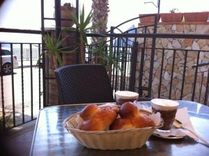 a basket of bread on a table with two cups of coffee at Gole dell'Alcantara Villa Lucia II in Motta Camastra