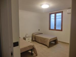 a room with two beds and a window at La Costa Est Villa con Vista Mare in Ogliastra Sardegna in Tertenìa