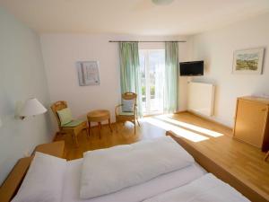 a bedroom with a bed and a table and chairs at Gästehaus FALKLAY in Burg (an der Mosel)