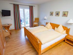 ein Schlafzimmer mit einem großen Holzbett in einem Zimmer in der Unterkunft Gästehaus FALKLAY in Burg (an der Mosel)