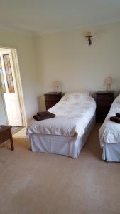 A bed or beds in a room at Lowerfield House