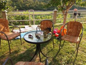 two chairs and a table and a table and chairs at Kuća Lavanda in Drežnjak