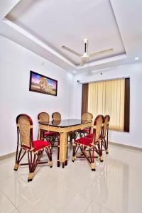 a dining room with a table and chairs at Rams Guest House Near Lulu Mall in Trivandrum