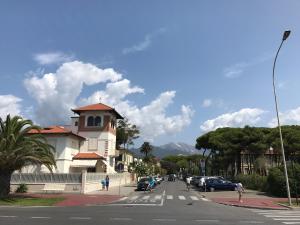 a street with a building on the side of a road at Stunning Apartment 300mt from the beach in Forte dei Marmi