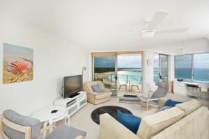 a living room with a couch and a tv at Beachpoint Unit 501 in Forster