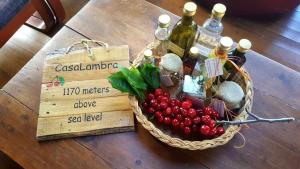 a basket of berries and bottles of wine on a table at CasaLambra Pedoulas Exclusive Accomodation Troodos Mountains in Pedoulas