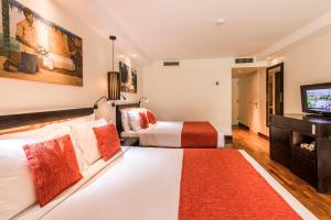a hotel room with a bed and a television at The Warwick Fiji in Korolevu