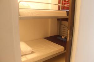 a small room with two bunk beds in it at Georgetown Heritage Motel in George Town
