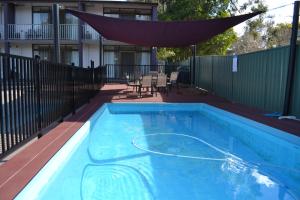 a swimming pool with a hammock over it at Parkhaven in Nowra