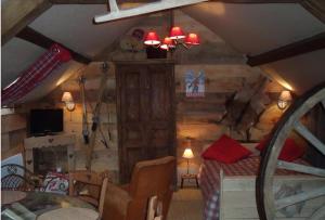 a living room with a bed in a wooden room at Gite Le Refuge in Vimoutiers