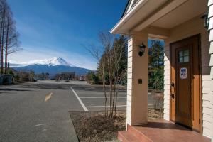 a view of a snow covered mountain from a parking lot at Yushin in Fujikawaguchiko