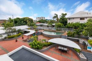 an image of the rooftop of a building with a swimming pool at Sunshine Tower Hotel in Cairns