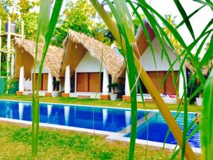a house with a swimming pool in front of it at Airport Resort in Katunayaka