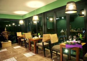 a dining room with tables and chairs and lights at Thai Story in Seogwipo