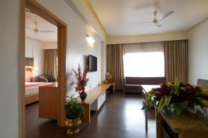 a hotel room with a bedroom and a living room at Dolphin Hotel in Visakhapatnam