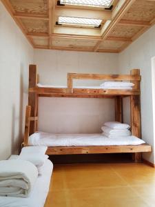 two bunk beds in a room with a skylight at The Hanok in Jeonju