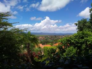 a view of a city from a hill with trees at Retreat Guesthouse Kitende in Entebbe