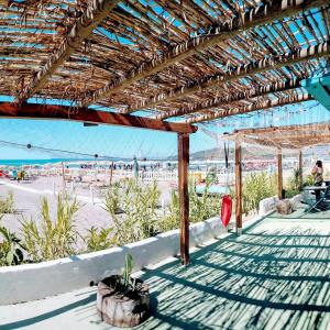 a pavilion at the beach with a view of the ocean at Baron Beach Hotel in Scauri