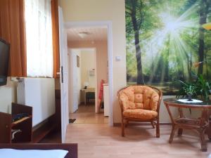 a hallway with a chair and a large painting on the wall at Dom wakacyjny u Mirka in Ustka