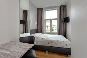 Кровать или кровати в номере Hotel Bor Scheveningen