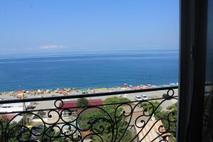 a balcony with a view of a beach and the ocean at Hotel Kvariati Nugo in Kvariati