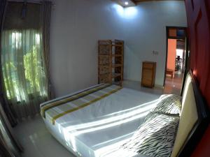 a large bed in a room with a window at Eddie's Homestay in Lhonga