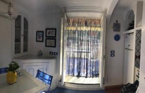 a kitchen with a large window and a table at casa vela in Positano