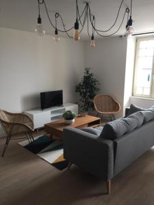 a living room with a couch and a table at La Houle in Cancale