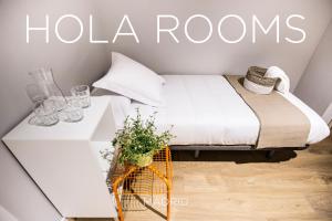 Un ou plusieurs lits dans un hébergement de l'établissement Hola Rooms