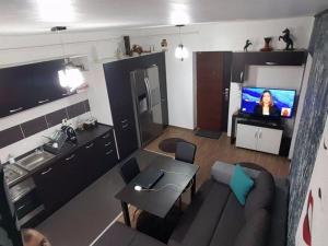 a living room with a couch and a tv at Apartament Brenda Sibiu in Sibiu
