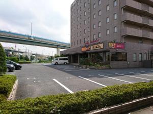 a car parked in a parking lot next to a building at Yono Daiichi Hotel in Saitama